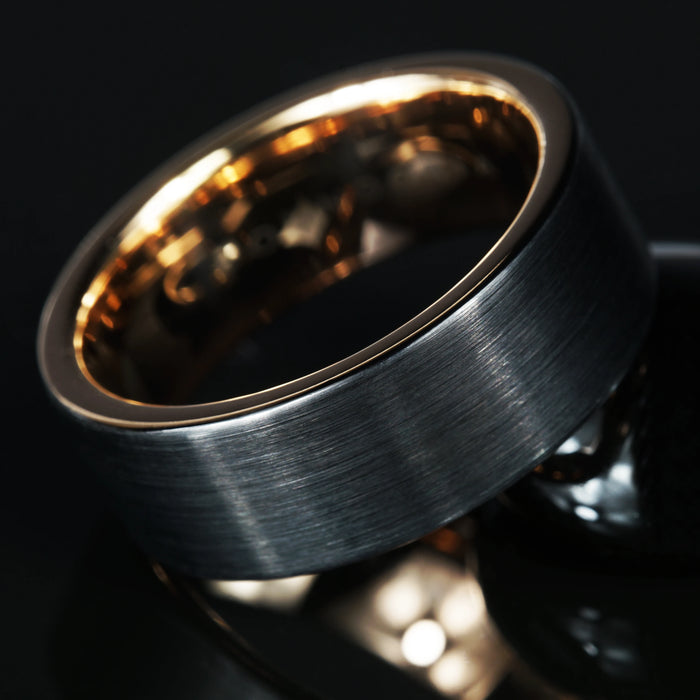 Aurin brushed black tungsten ring with a rose gold interior sleeve